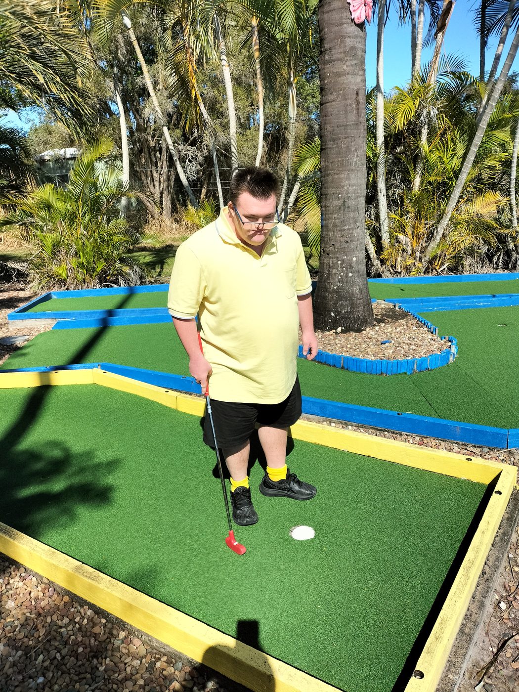 Client playing mini golf outdoors