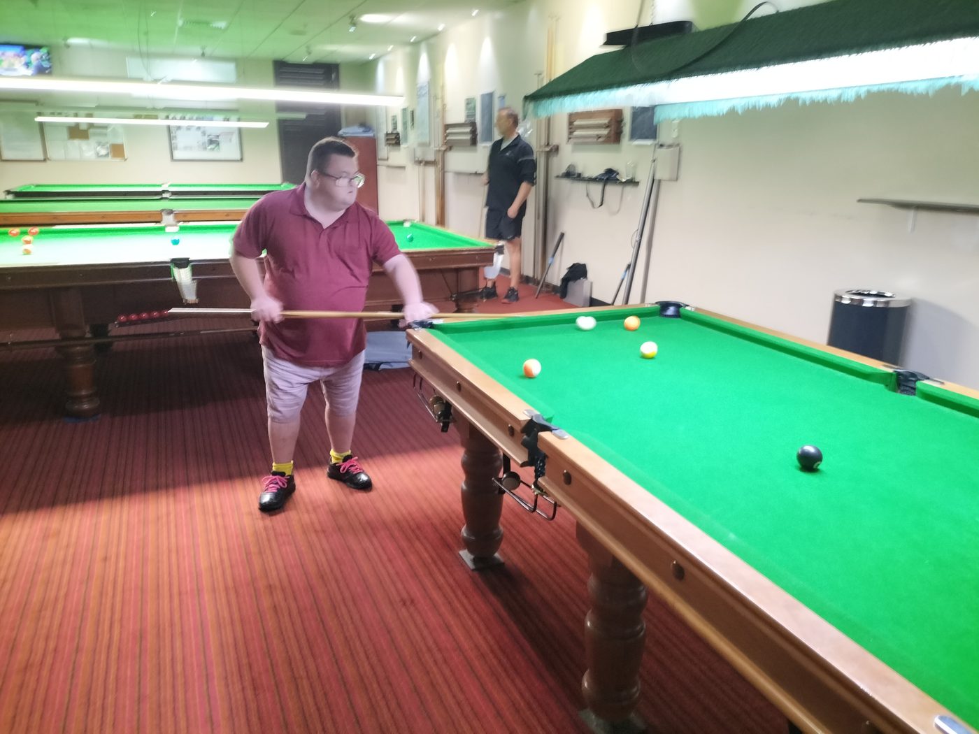 Client playing pool at a local venue